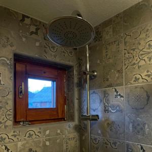 a bathroom with a window and a shower at The Tara Concept in Šljivovica