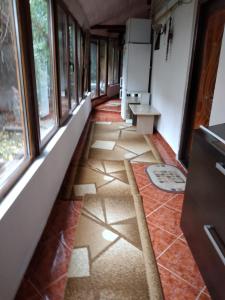 a hallway of a room with windows and tile floors at Ada-Ini House in Craiova