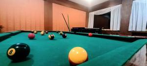 a pool table with balls on top of it at Hotel Bucaneve in Moena