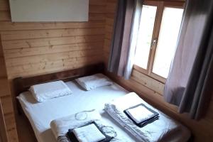 a small bed in a room with a window at Happy Cottage - Banská Bystrica in Banská Bystrica