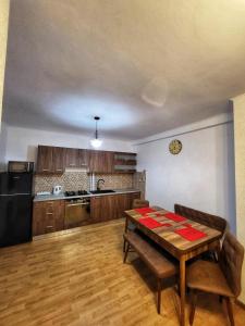 a kitchen with a table and a dining room at La Simo in Sinaia