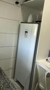 a white refrigerator in a kitchen next to cabinets at FLAT VILLA MONTE CASTELO in Bezerros
