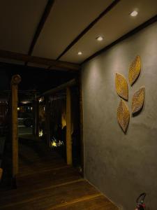 a wall with leaves on it next to a porch at Pousada Ares de Noronha in Fernando de Noronha +68 photos