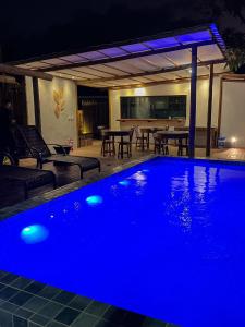 a swimming pool with blue lighting in a house at Pousada Ares de Noronha in Fernando de Noronha