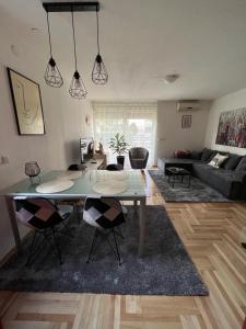 a living room with a table and chairs in it at Apartman West - private parking place in Zagreb