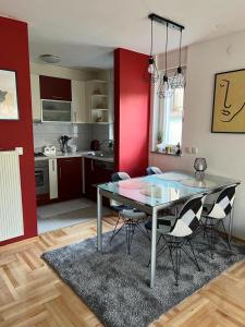 a kitchen with a glass table and chairs in a room at Apartman West - private parking place in Zagreb