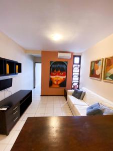a living room with a couch and a painting on the wall at Apartamentos Orrit Real Estate in Pipa