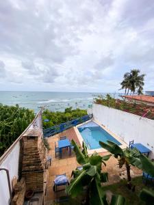 an ocean view from the balcony of a house with a swimming pool at Apartamentos Orrit Real Estate in Pipa