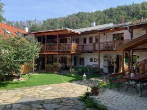 a large house with a patio and a yard at Frühstückspension Eibenstein in Eibenstein