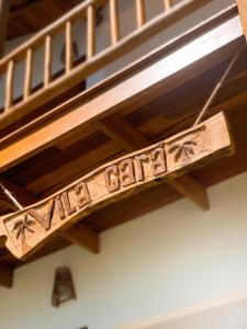 a wooden stair railing with the words american grill on it at Vila Gará Kite House - Ilha do Guajiru in Itarema