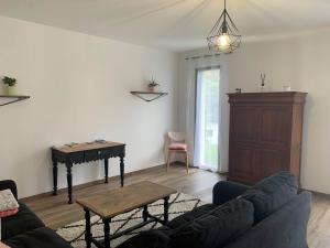 a living room with a table and a piano at Gîte Camdeborde 2 personnes au cœur du village de Laruns in Laruns