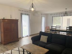 a living room with a couch and a table at Gîte Camdeborde 2 personnes au cœur du village de Laruns in Laruns