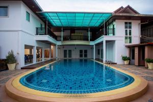 a swimming pool in the middle of a house at Sea Paradise Hotel Sattahip in Sattahip