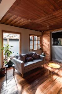 a living room with a couch and two tables at Hotel Alma Pucón in Pucón