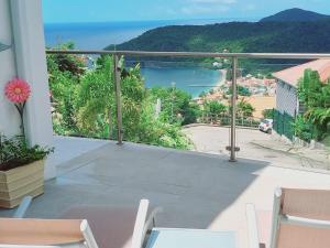 a balcony with a view of the ocean at Le DAMOUR Appartement 1 ou 2 chambres in Les Anses-dʼArlets