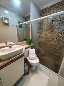 a bathroom with a sink and a toilet and a shower at Casa 3quartos rota Maragogi Carneiros in São José da Coroa Grande +17 photos
