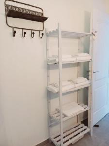 a walk in closet with white shelving at Le DAMOUR Appartement 1 ou 2 chambres in Les Anses-dʼArlets