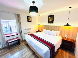 Postel nebo postele na pokoji v ubytování Hotel Rojas Inn