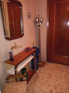 um quarto com uma mesa de madeira e um espelho em B&B Viale Liberta Giarre (CT) em Giarre