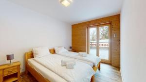 Postel nebo postele na pokoji v ubytování Les Mayens LUXURY & COSY apartments