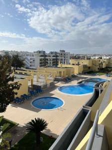 a view of a resort with two swimming pools at Condominio do Mar in Lagos