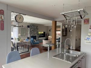 a kitchen and living room with a sink and a counter at grande villa familiale in Saint-Pair-sur-Mer