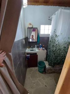 a bathroom with a sink and a mirror at La Casa del Naufrago in Lobitos