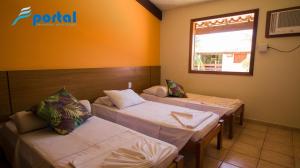 Tempat tidur dalam kamar di Apart Hotel Portal Do Atlântico - Portal Hotéis