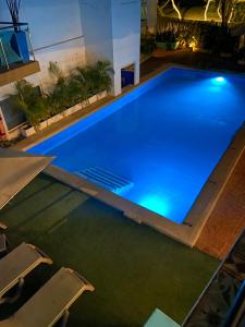 an overhead view of a large swimming pool at night at The Cantamar Beach Hostel in Santa Marta