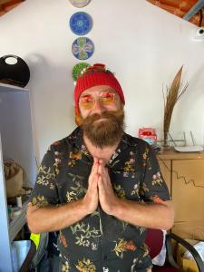 a man with a beard and a red hat and glasses at SHANKAR by the SEA, 2 min from Mandrem Beach in Mandrem