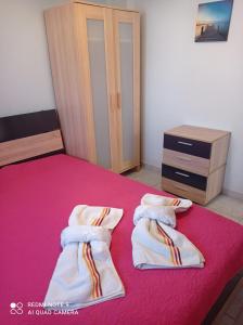 A bed or beds in a room at "By The Sea" Family apartments