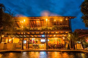 a house with a pool in front of it at night at Dreamer Santa Marta in Santa Marta