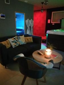 a living room with a couch and a table at Le NaturOspa in Le Quesnoy-en-Artois
