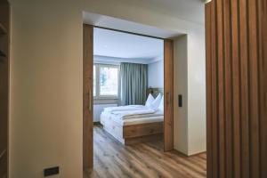 A bed or beds in a room at Brandnerhof