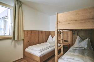 A bed or beds in a room at Brandnerhof