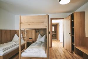 A bed or beds in a room at Brandnerhof