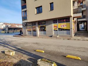 an empty street in front of a building at Apartman Dobrinja in Sarajevo +7 photos