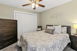 a bedroom with a bed and a ceiling fan at Cottage By David Rigney Real Estate Solutions in Lake Geneva