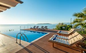 a villa with a swimming pool and the ocean at Iris Villas Lefkada - Karavi Villa in Évyiros