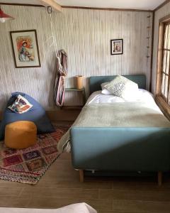 a bedroom with a blue bed in a room at Departamento La Solar 1 ambiente in Frutillar
