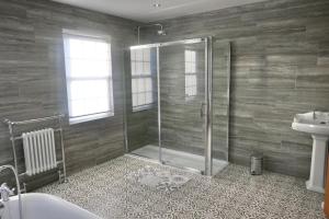 a bathroom with a shower and a toilet and a sink at Marehay Hall Farm in Belper
