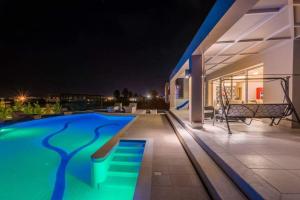 a house with a swimming pool at night at Villa Fotaki in Kos Town
