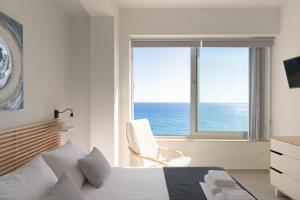 a bedroom with a bed and a view of the ocean at Villa Thalassa in Ferma