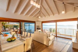 a dining room with a view of the ocean at Iris Villas Lefkada - Marine Villa in Évyiros