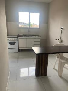 a kitchen with a table and a sink in it at Hotel do Valle in Tijucas