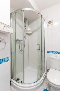 a glass shower in a bathroom with a toilet at "Furnished Rentals Direct" DominionHouse cul-de-sac Home for 6 people in Anfield near LFC, Goodison Park, Free Street Parking, Suits Travellers, contractors and Family, Near Football action and 10 minutes drive to Liverpool City Centre in Liverpool