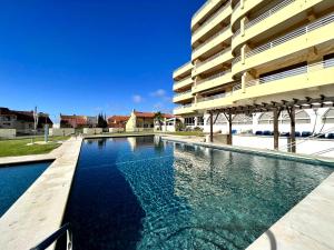 a swimming pool in front of a building at Vilamoura Marina Mar 1 with Pool by Homing in Vilamoura