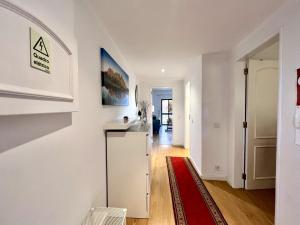 a kitchen with a white refrigerator and a red rug at Vilamoura Marina Mar 1 with Pool by Homing in Vilamoura