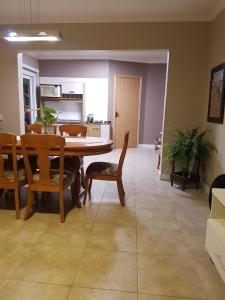 a living room with a dining room table and chairs at KIKO in Tramandaí
