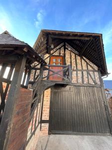 a wooden gate to a building with a sky background at Cozy loft in Normandy in Saint-Gâtien-des-Bois